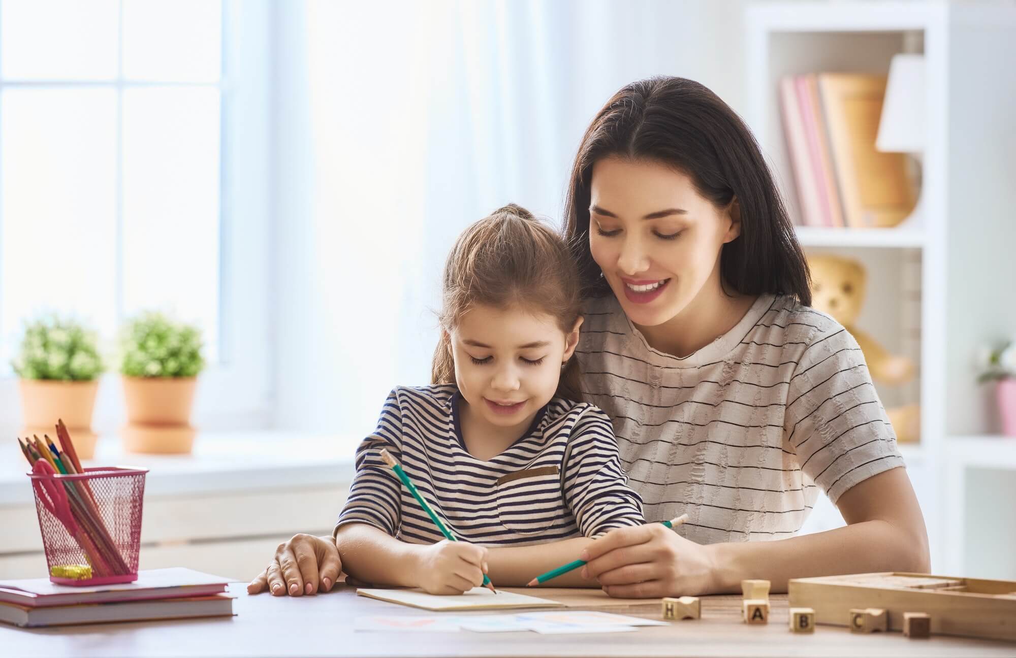 Mother homeschooling daughter in Hong Kong